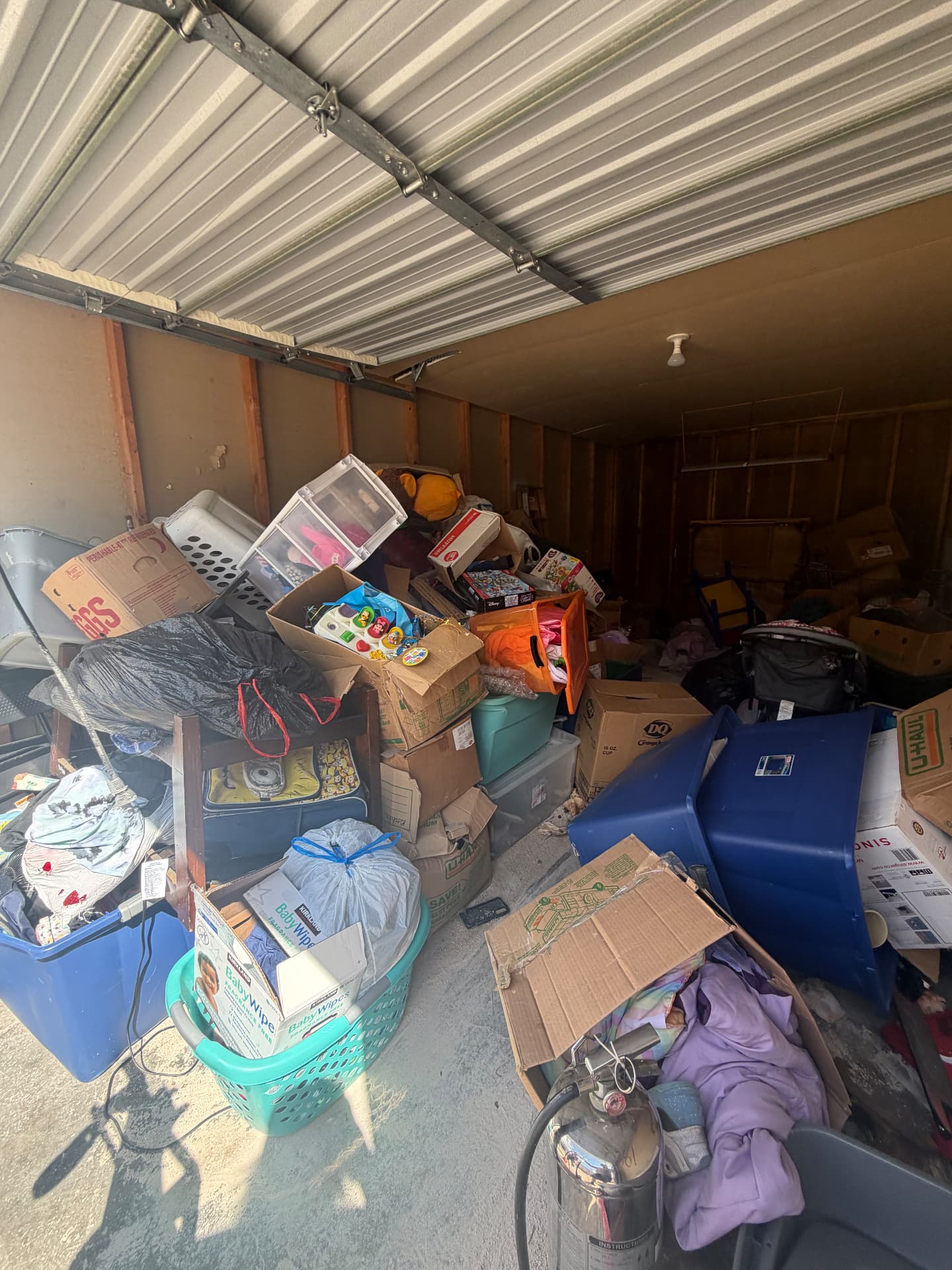 Before: a garage filled with boxes and clutter awaiting cleanout