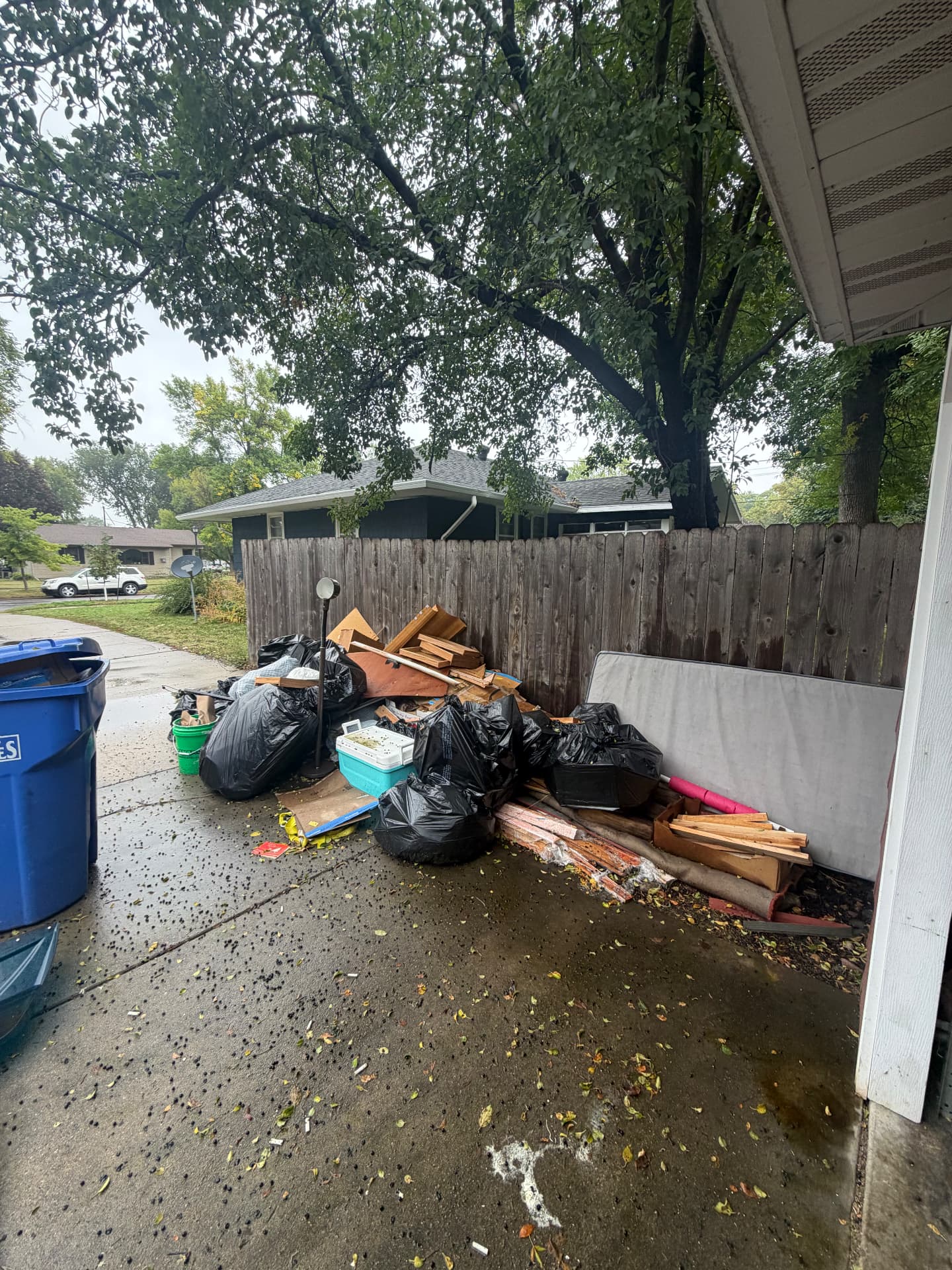 Before: bags and junk piled beside the house awaiting removal